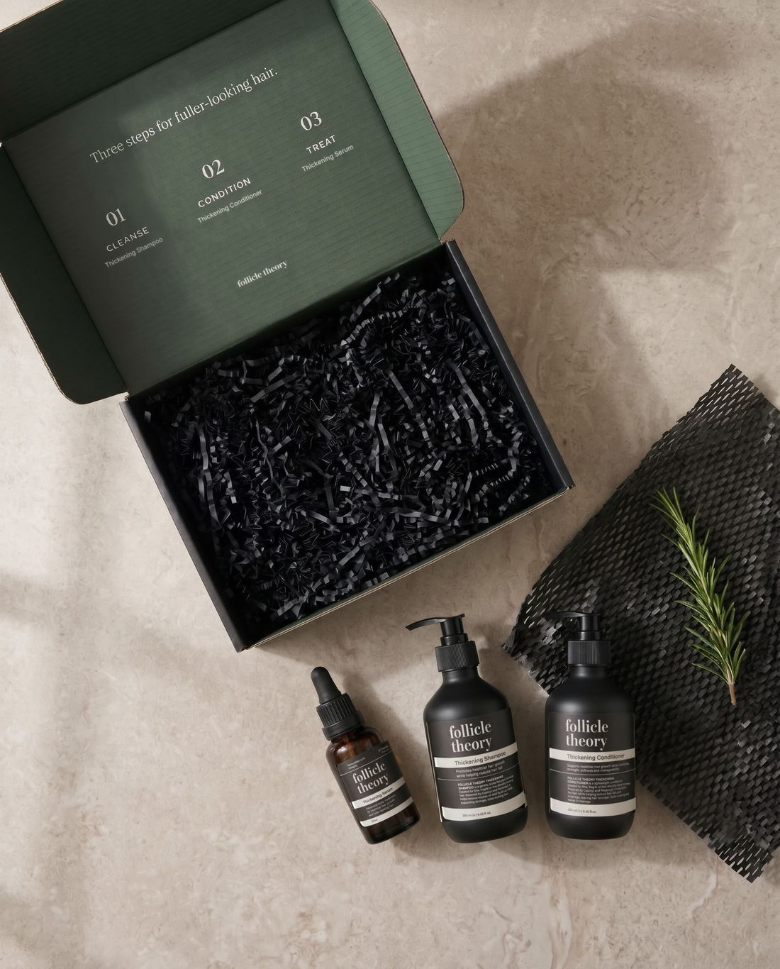The Thickening System gift box, open, with all three follicle theory products